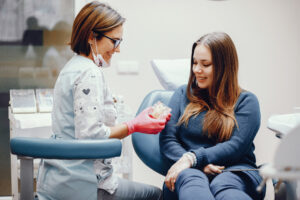 Girl talking to the dendist. Beautiful lady in the dentist's office. Woman in a uniform